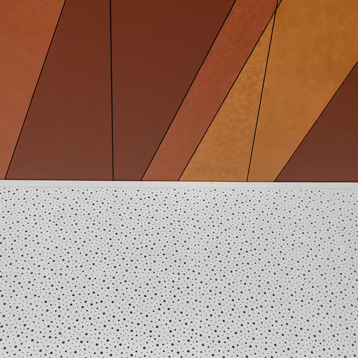 Angled timber-toned wall panels above a perforated ceiling